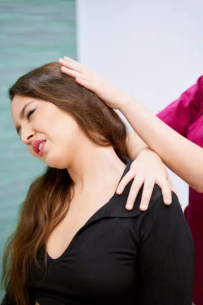 woman with muscle strain experiencing neck pain