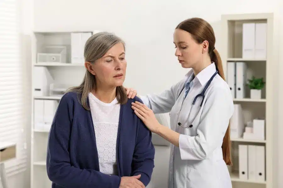 A chiropractor checks the shoulder of an old woman at Better Care Chiropractic and Physical Therapy in Montgomery and Willis