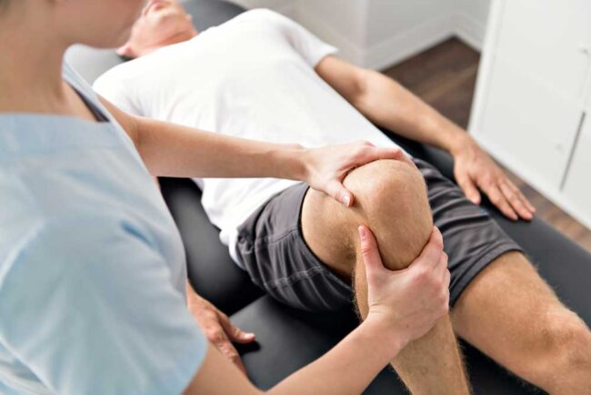 A chiropractor checks the shoulder of an old woman at Better Care Chiropractic and Physical Therapy in Montgomery and Willis