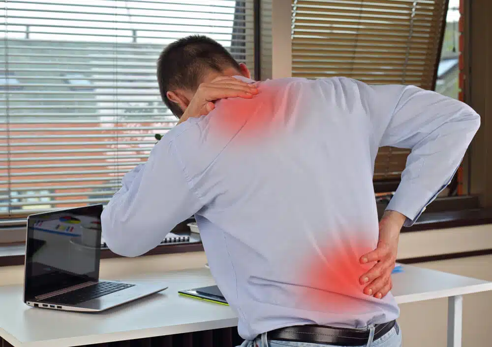 A chiropractor checks the shoulder of an old woman at Better Care Chiropractic and Physical Therapy in Montgomery and Willis